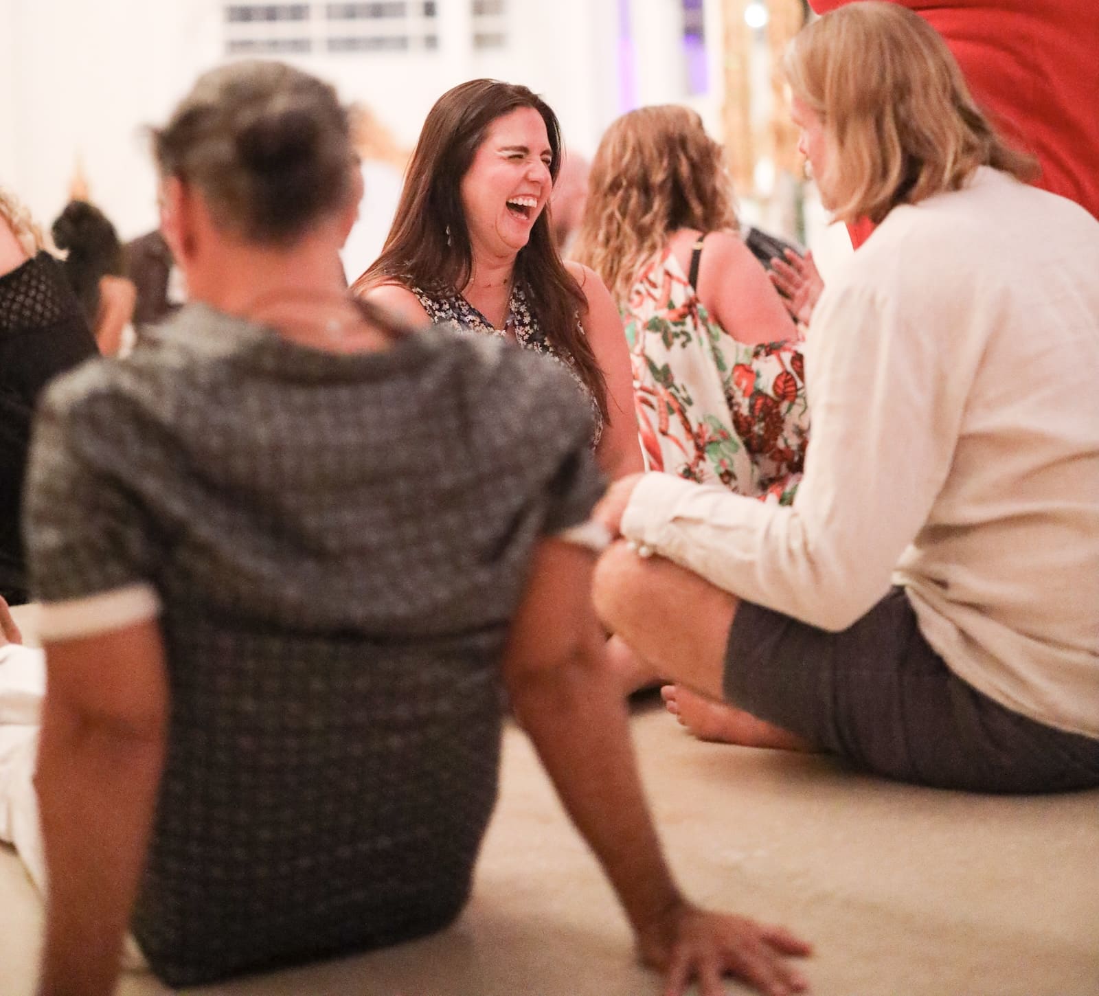 Singles laughing together during a Tantra Speed Date event.